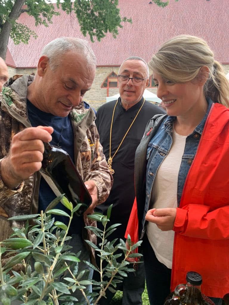 Georges Karam sharing olive oil with visitors