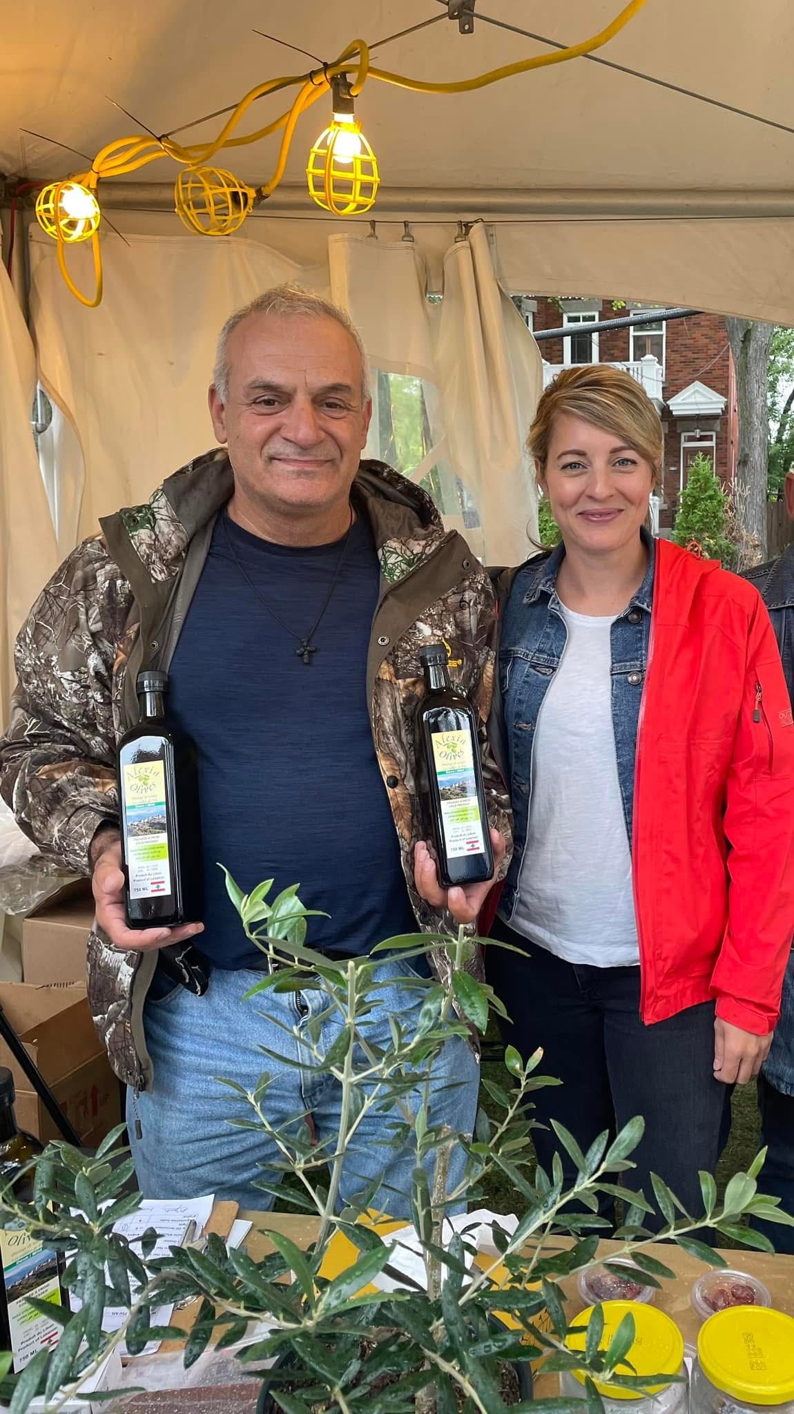Georges Karam holding bottles at the market